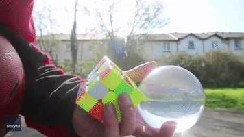 Master Multitasker: Man Completes Rubik's Cube and Juggles While Riding Unicycle