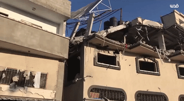 Collapsed Roof and Damaged Vehicles at Site of Deadly Israeli Strike on Gaza Militant