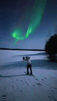 Spectacular Northern Lights Display Seen Above Skier