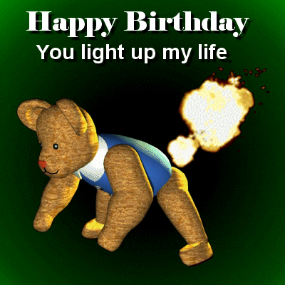 Digital art gif. A teddy bear is leaning over and farts. A flame ball comes out of its backside and the text on top reads, "Happy Birthday. You light up my life."
