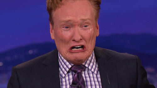 TV gif. Conan O'Brien crying absurdly and overdramatically with visible streaming tears down his face.