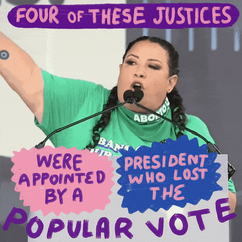 Video gif. Woman wearing a bright green t-shirt speaks emphatically at a podium above a sign that reads, "Bans off our bodies." She says, "Four of these justices were appointed by a president who lost the popular vote."