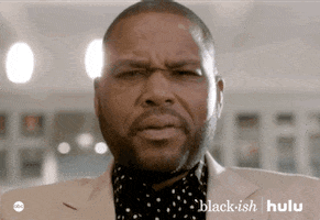 TV gif. Anthony Anderson as Andre in Blackish stares down at us, eyebrows furrowed as he slowly mouths the word, "Damn."