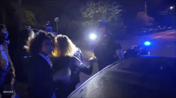 Motorcycle Officer Drives Through Protesters Blocking Pursuit of Suspect