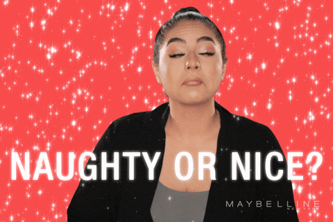 Video gif. Woman surrounded by falling animated snow, text below her reads “Naughty or nice?” The woman’s eyes go wide as she looks at and considers the two options from the text below her.