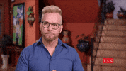 Reality TV gif. Kenny from 90 Day Fiance brings his hands to his lips in a gesture of hopefulness.