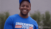 Sports gif. Bodybuilder grins at us while flexing a bicep. He says, "Boom!" as he flexes his arm and shakes it up and down.