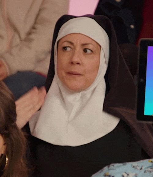 Video gif. A flustered nun fans herself with one hand as she takes a deep breath in. 