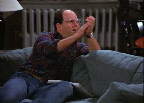 Seinfeld gif. Jason Alexander as George Costanza with a pen in his mouth, clapping sarcastically.