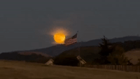 Moon Glows Over California Mountain Skyline Ahead of First Supermoon Event