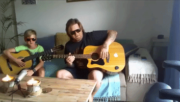 Father and Son Play Acoustic Guitar Duet