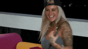 Reality TV gif. Tattooed, platinum-blonde contestant from Ex on the Beach curls her fist and pumps her elbow victoriously, mouthing "yes!"