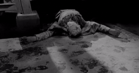 Movie gif. In the ending scene of Stakeout On Dope Street, a potentially dead person is laying flat on the ground with their arms spread out and the text says, "The End."