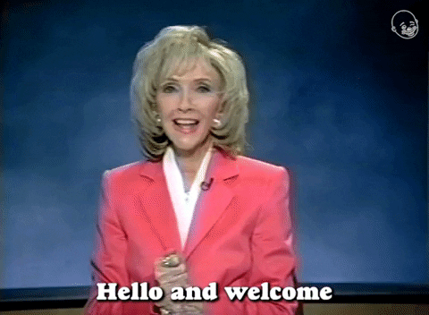 Video gif. A middle-aged woman, dressed 90s broadcast professional, says "Hello and welcome, to a very very special video, that we are delighted, to bring into your home."