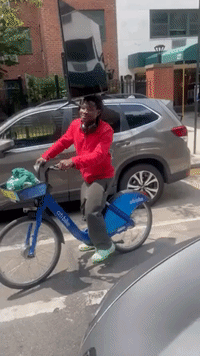 'Only in New York': Man Rides Bike With TV on His Head