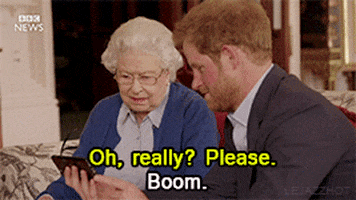 Celebrity gif. Prince Harry holds up his phone in front of Queen Elizabeth as she says, "Oh, really? Please." Then Harry turns to us and opens his hand like its dropping a bomb while he smiles and says, "Boom."