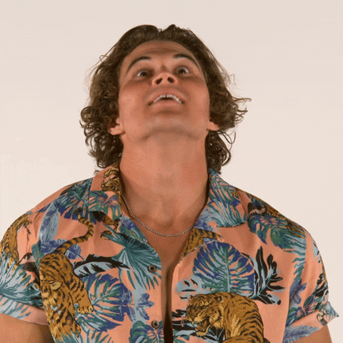 Reality TV gif. A contestant from Big Brother takes a deep breath before letting out a holler to hype himself up.