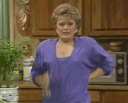 TV gif. Rue McClanahan as Blanche from the Golden Girls. She's gotten hot and aroused and has one hand clasped behind her back while the other sprays herself with a spray bottle as she tries to cool herself.