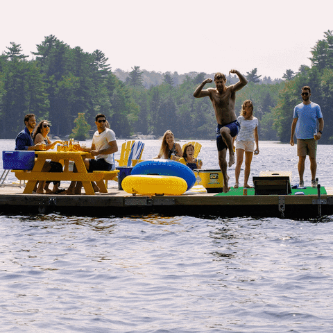 Ad gif. A man cannonballs into the lake as a party of friends watch from the dock.