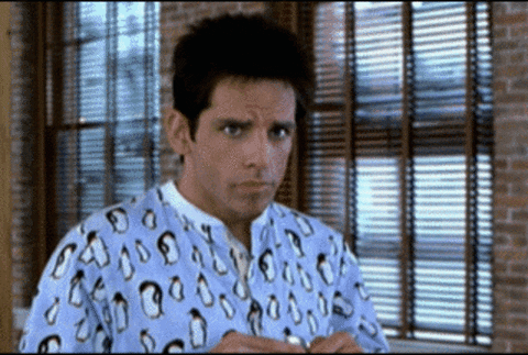 Movie gif. We zoom in on Ben Stiller as Derek Zoolander as he slowly smiles with surprise and then tosses his arm out as if to say, "You shouldn't have."