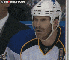 Sports gif. Hockey player sits with his eyebrows furrowed in a penalty box and widens his eyes in utter disbelief as he begins to protest by incredulously saying, "What?"