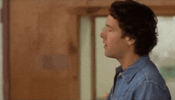 Movie gif. Looking mad and frustrated, Paul Rudd as Andy in Wet Hot American Summer rolls his head back then throws something.