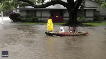 Father Leads Kids From School in Kayak