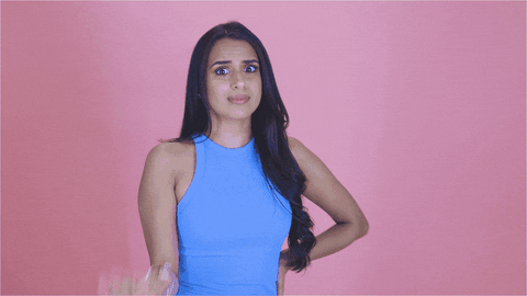 Video gif. TV personality Monica Vaswani in a high rising, light blue dress stops us with her hand and wags her index finger. She stares at us as if warning us to not make the same mistake.