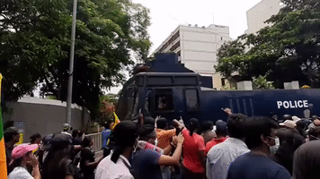 Anti-Government Protestors March Past Police in Colombo