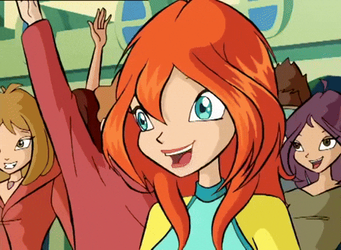 Cartoon gif. Bloom on Winx Club stands in front of a crowd of people with their hands up. She holds a thumbs up and winks with a big smile.