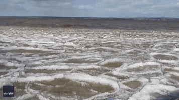 Ice Waves Glide Over Lake Superior Shore in Ashland, Wisconsin