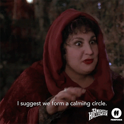 Movie gif. Kathy Najimy as Mary Sanderson from Hocus Pocus makes a gentle suggestion. Text, "I suggest we form a calming circle." But Bette Midler, as her sister Winifred, shouts the idea down. Text, "I am calm!"