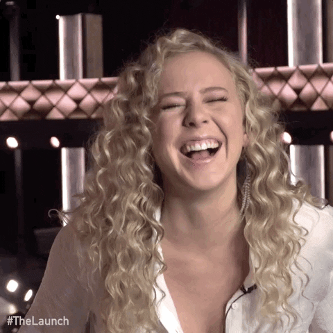 Reality TV gif. Maddie Storvold from The Launch laughing hard and doubling over.
