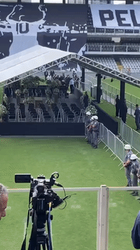 Pele's Coffin Arrives at Santos Stadium for Lying in State
