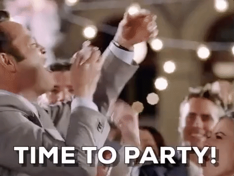 Movie gif. Vince Vaughn as Jeremy Grey in Wedding Crashers stuffs cake into his mouth while standing next to the bride and shouting "Time to party." 