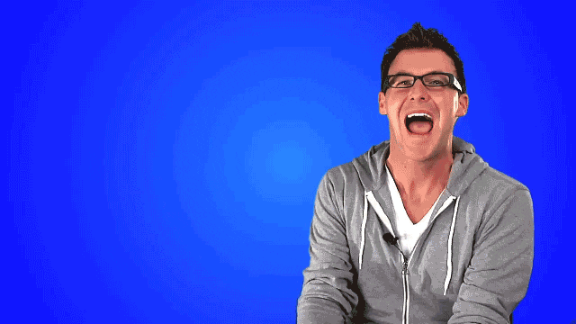 Video gif. Michael Buckley, a Youtuber, smiles broadly at us and says, "Happy Monday!"