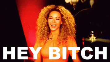 Celebrity gif. Beyonce smiles at us and cocks her head to the side, looking sweet and upbeat as she says, "Hey bitch," which appears as text.
