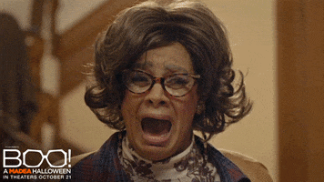 Movie gif. Tyler Perry as Madea and Patrice Lovely as Hattie in Boo! A Madea Halloween scream at each other with terror in their eyes. 