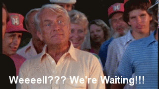 Movie gif. Ted Knight as Judge Elihu Smails in Caddyshack, stands in a yellow polo shirt in a group of people. The elderly white man eyes grow wide. He shakes his head and leans his head forward with an exaggerated, open mouth. Text reads, Weeeell???We're Waiting!!! Movie gif. Ted Knight as Judge Elihu Smails in Caddyshack, stands in a yellow polo shirt in a group of people. The elderly white man eyes grow wide. He shakes his head and leans his head forward with an exaggerated, open mouth. Text reads, Weeeell???We're Waiting!!!