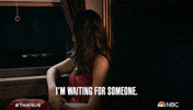 TV gif. Mandy Moore as Rebecca in This Is Us looks despondently out a window in a vintage train car as she says, "I'm waiting for someone."