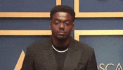 Celebrity gif. Daniel Kaluuya looks around, zoning out as if trying to remember something at the Academy Awards in 2021.