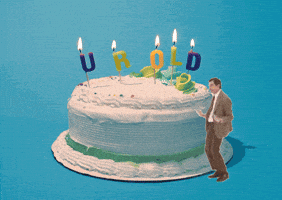 Video gif. Rowan Atkinson as Mr. Bean dances, thrusting his hips, in front of a large white birthday cake. On top of the birthday cake are candles that spell out “Your Old.”