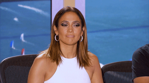 Reality TV gif. American Idol judge Jennifer Lopez's expression is unreadable, but her eyes move up and down as she looks someone over.