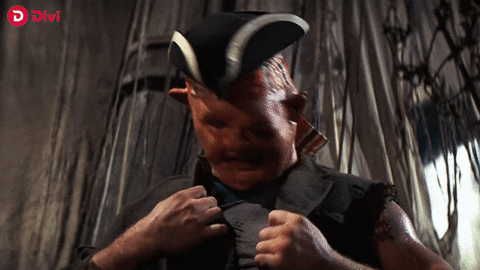Ad gif. Altered scene from the Goonies where, on a boat, John Matuszak as Sloth rips off his shirt and reveals a Divi Project logo, which shocks his mom, played by Anne Ramsey.