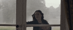 Movie gif. Amelia Crouch as Charlotte in The Cursed desperately tries to open a locked door. She pounds her open palms on the glass and screams, “help!”
