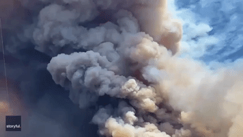 Plane Drops Retardant Over California's Apple Fire as Blaze Prompts Thousands to Evacuate