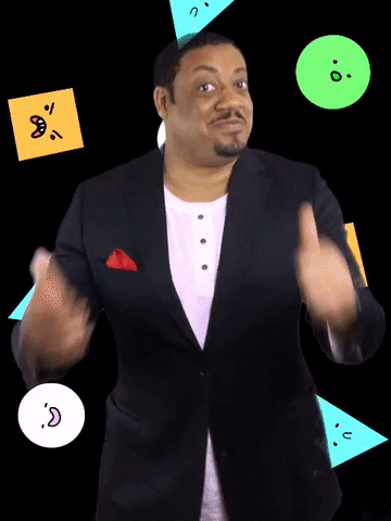 Celebrity gif. Cedric Yarbrough smiles at us and gives two thumbs up while nodding. Behind him, triangles, circles, and squares with different faces fall in the background.