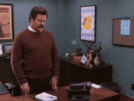 Parks and Recreation gif. Nick Offerman as Ron stares intensely at the floor before looking right at us with a confused expression and saying, "What the hell just happened?" which appears as text.