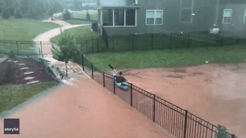 Man Test Runs New Kayak in Flooded Backyard in North Carolina