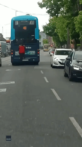 'Lunatic!': Man Hitches Ride on Back of Dublin Bus